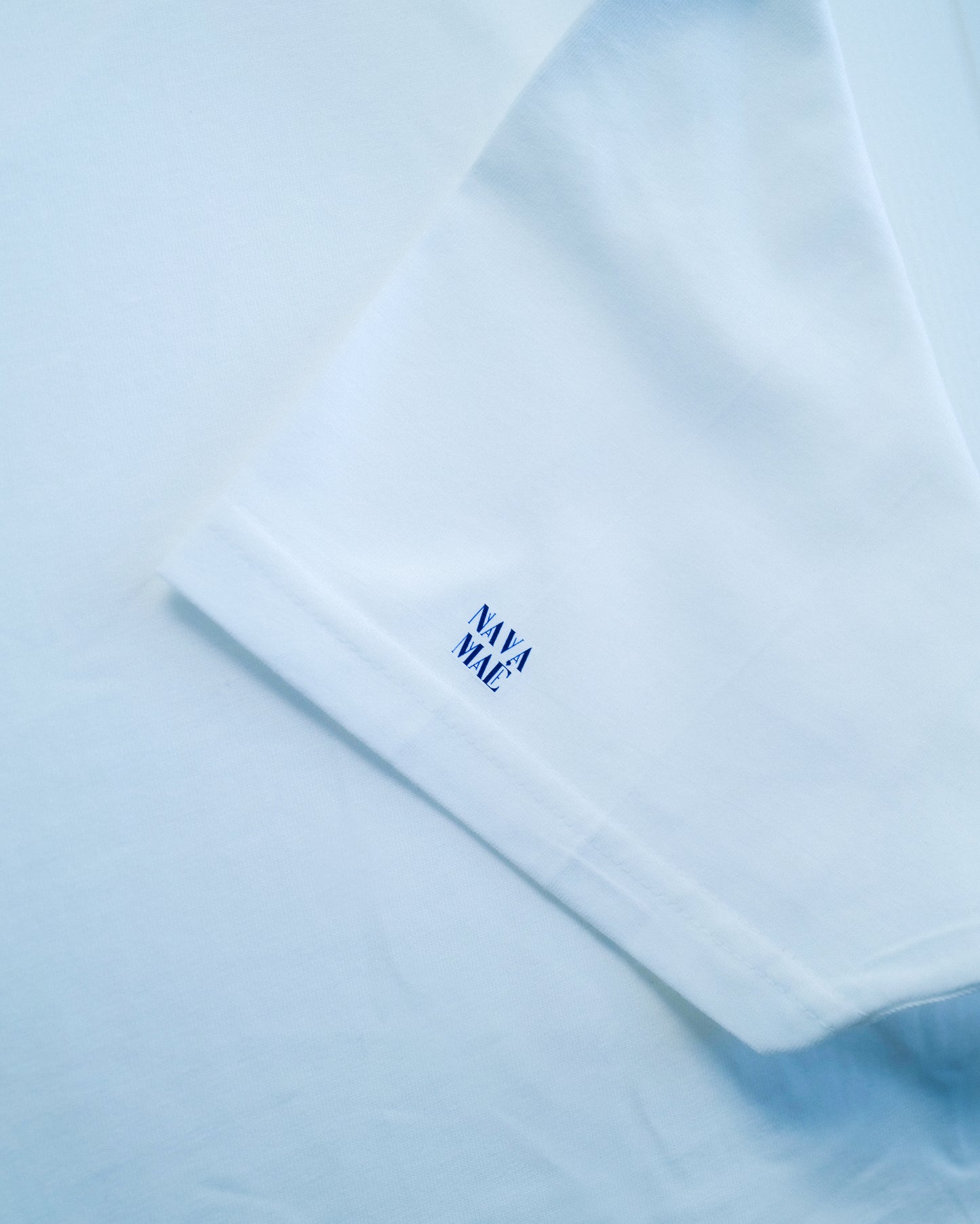 Close-up of Nava Mae tshirt with logo on sleeve