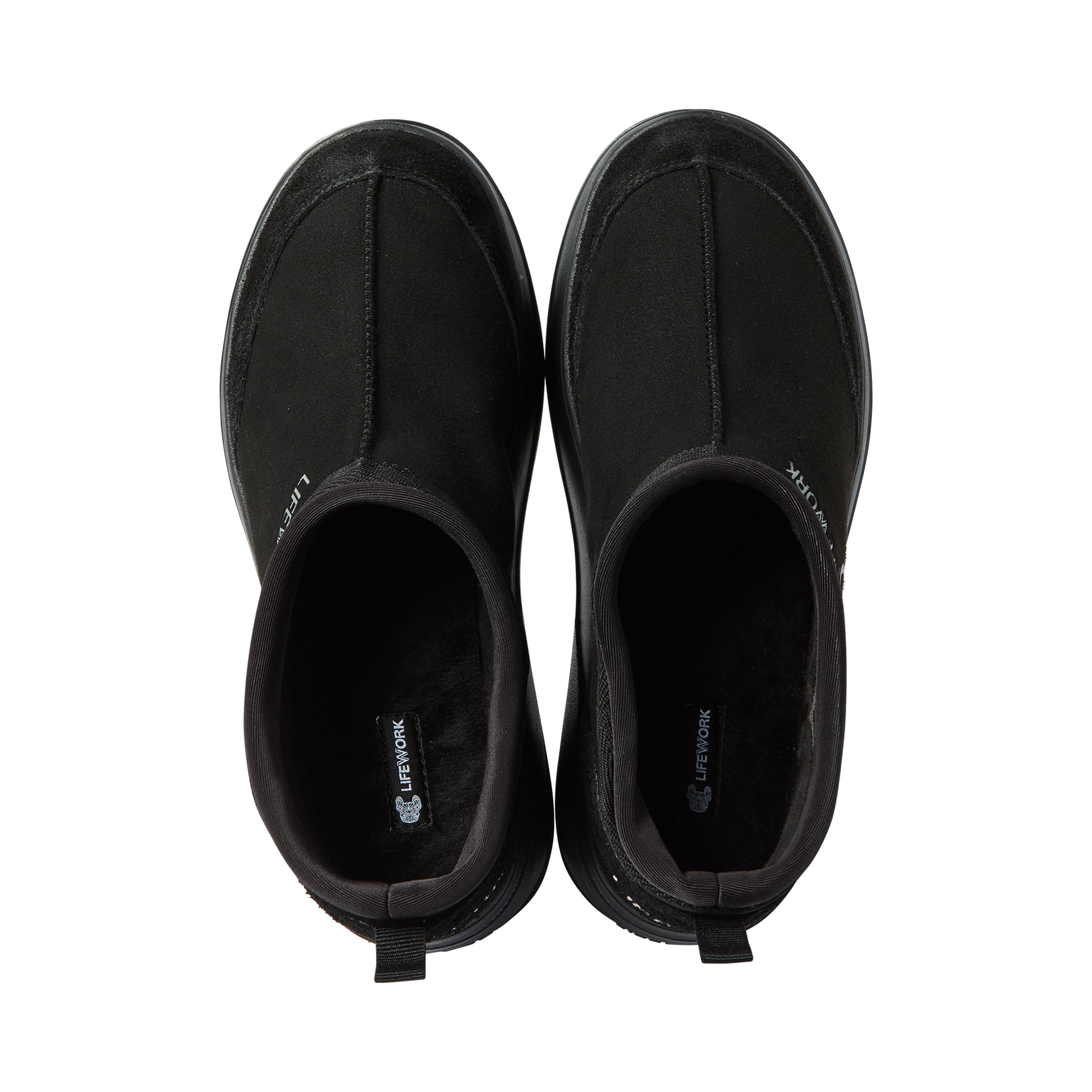 Pair of black slip-on shoes on a white background
