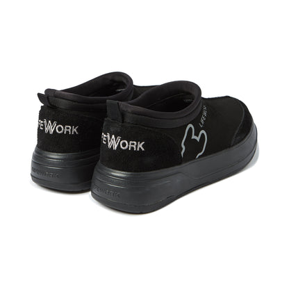Black slip-on sneakers with 'New York' branding on a white background