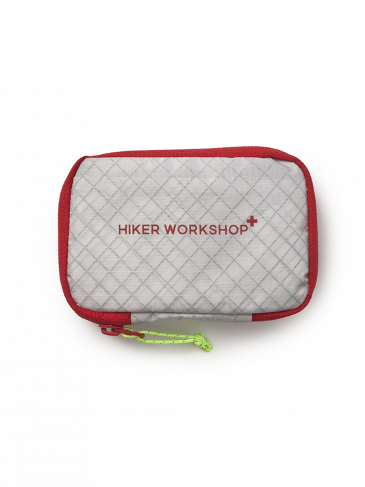 Quilted pouch with red zipper and Hiker Workshop logo for first aid