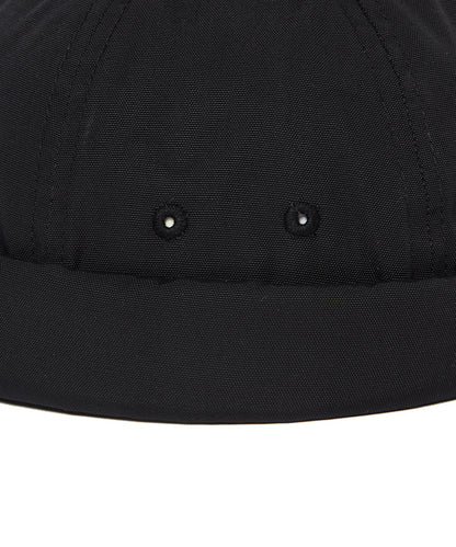 Close-up of a black cap with two buttons on a white background