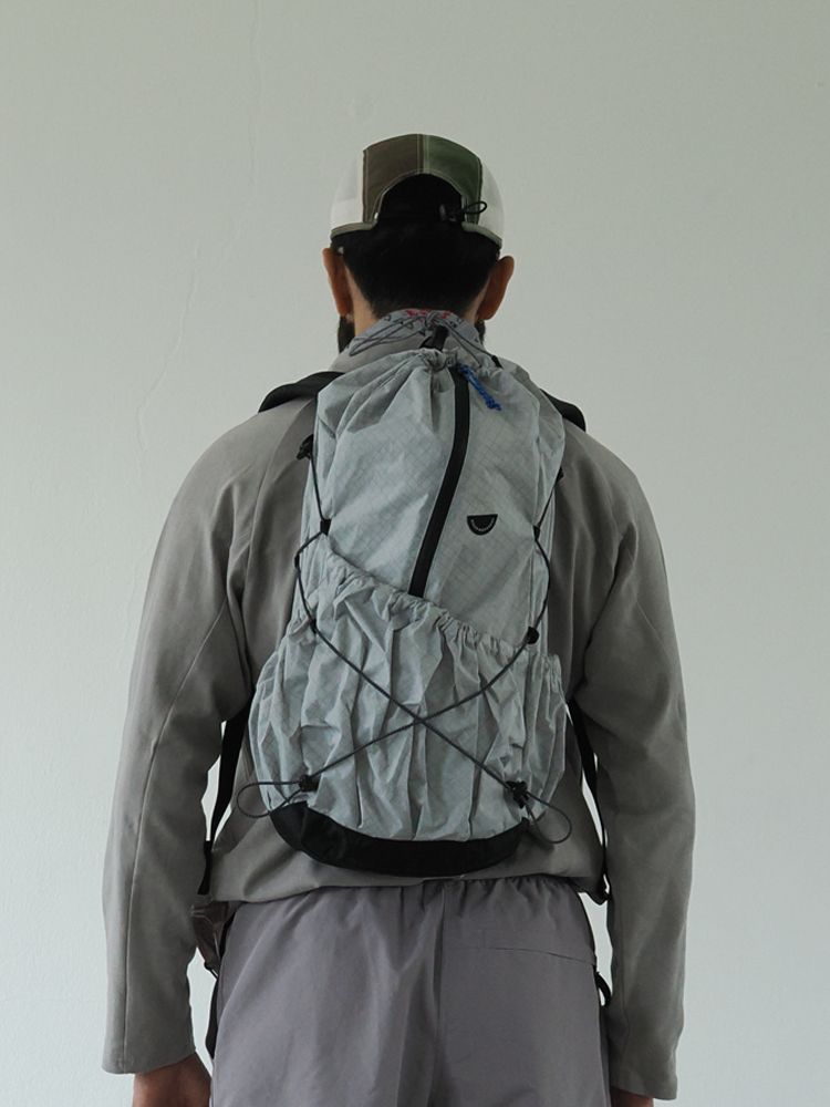 Person wearing a gray lightweight backpack 